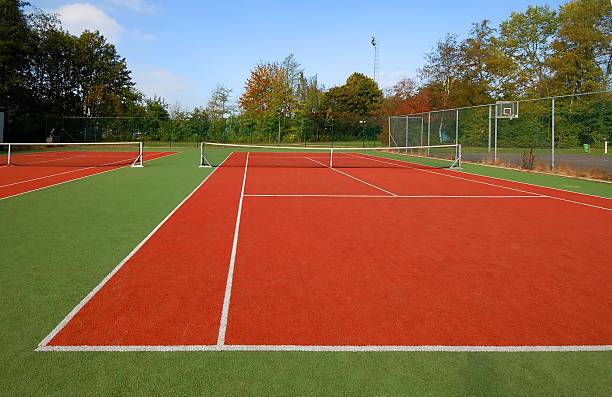 tennis court under blue sky stock photo