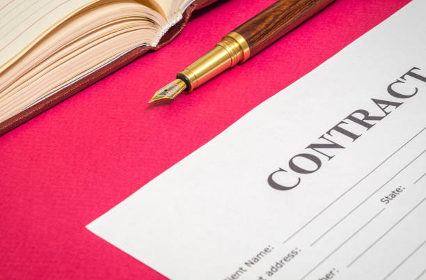 istock Contract formation elements a stylish pen and blank on red office desk 1451848576