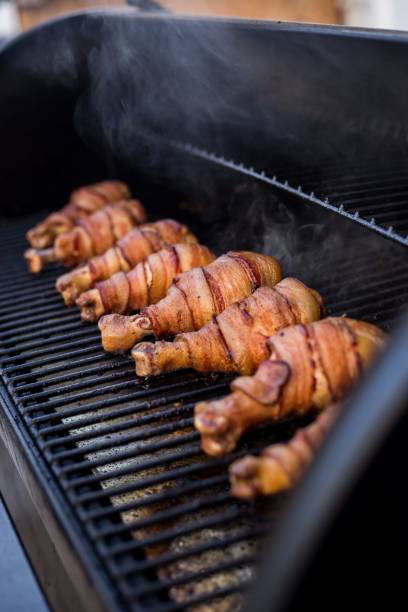 istock Grill with chicken legs wrapped in bacon 1451849122