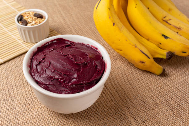 istock Acai bowl with banana and cereal on burlap cloth. 1451849382