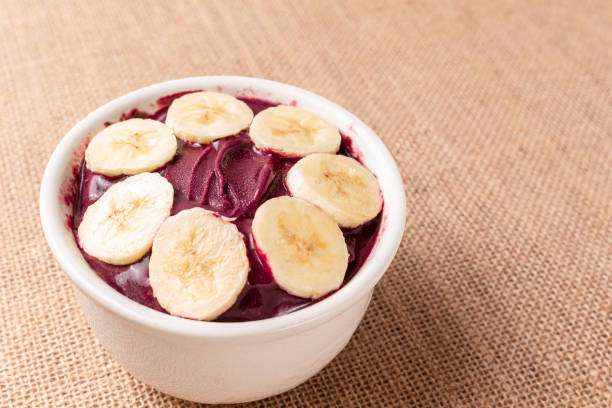 istock Acai bowl with banana on burlap cloth. 1451849474