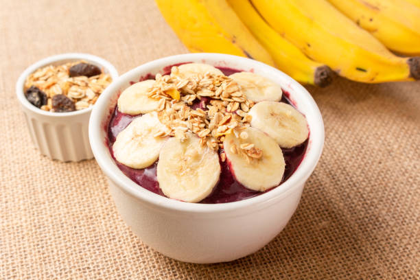 istock Acai bowl with banana and cereal on burlap cloth. 1451849482