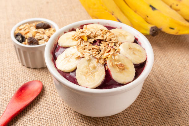 istock Acai bowl with banana and cereal on burlap cloth. 1451849493