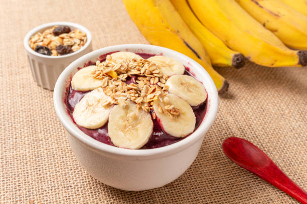 istock Acai bowl with banana and cereal on burlap cloth. 1451849527
