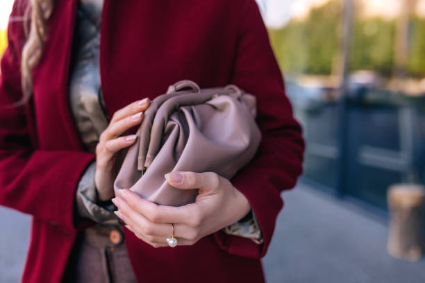 istock girl holds a leather bag beige 1451850019