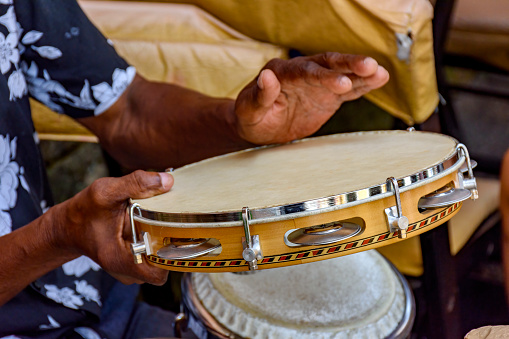 A traditional Moroccan band entertaining with dance and instruments in Marrakesh.  The musicians are playing the traditional Gnawa Iron Castanets.  These musicians are playing classical Andalusian music and were singing in Arabic. Music and a performance such as this is usually seen at religious ceremonies, festivals, concerts and weddings. The musicians are dressed in the traditional Moroccan clothing.