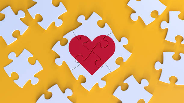 Red Heart Shape On The Jigsaw Puzzle Pieces. stock photo