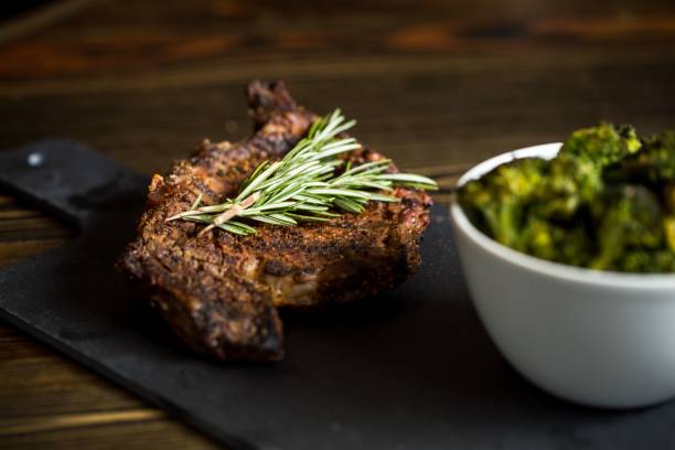 istock Beef steak and bowl of broccolis on a board 1451853250
