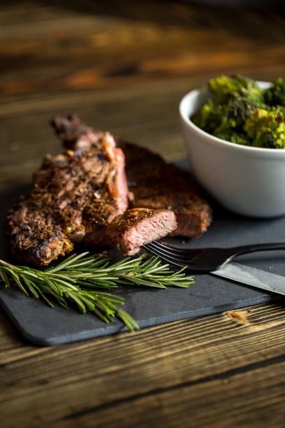 istock Beef steak and bowl of broccolis on a board 1451853319