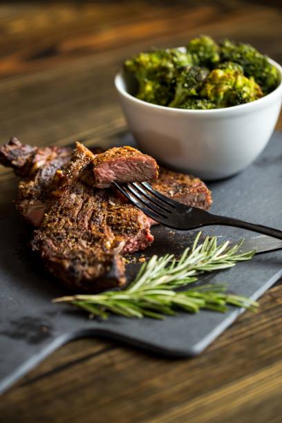 istock Beef steak and bowl of broccolis on a board 1451853357