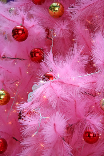 Closeup of a pink christmas tree with ornaments