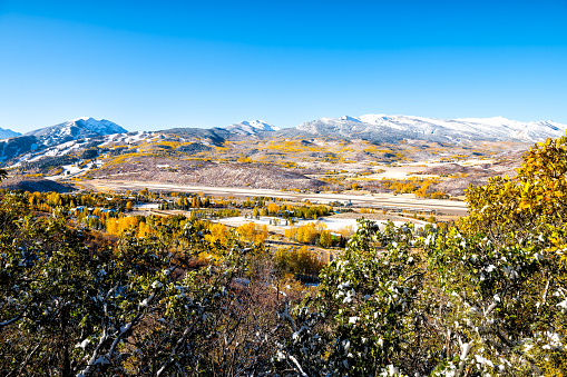 Aspen, Colorado city at Rocky mountains Roaring fork valley high angle view of airport at autumn and snow by Buttermilk ski resort slope mountain