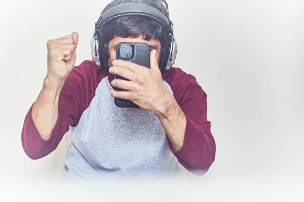 istock Man using headphones and phone 1451853755