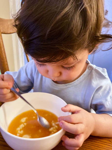 istock Boy eating soup at home 1451854346