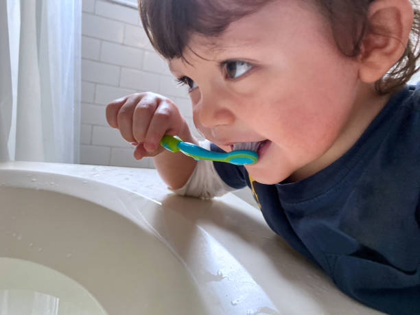 istock Boy brushing teeth at home in a bathroom 1451854669