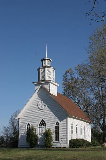 Small Country Church Rural church in Southern Arkansas with sharp and tall steeple. methodist stock pictures, royalty-free photos & images