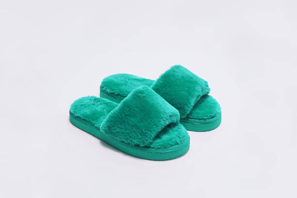 Green woollen slippers on white background