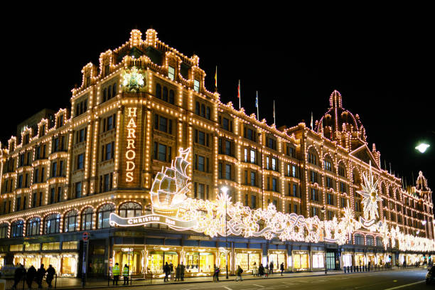 London, UK, DEC 6 2022: Harrods luxury department store with Christmas decorations at night. It is located on Brompton Road in Knightsbridge, London, England.
