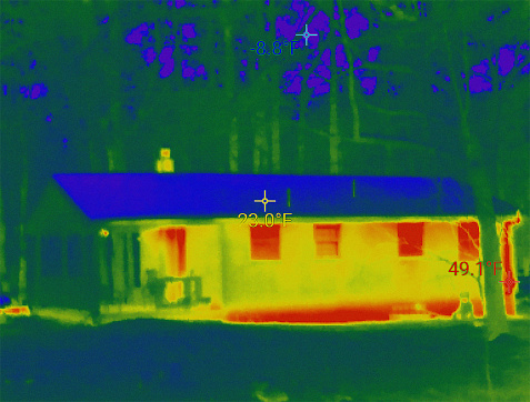 The rising of energy prices force us to monitor heat loss. Exterior of a house taken with a heat-sensing camera showing higher amounts of heat emitted in the brighter parts.