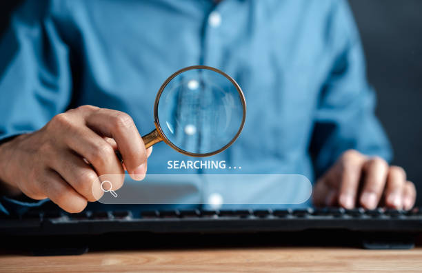 istock Businessman use magnifying glass Search On Virtual Screen Data Search Technology Search Engine Optimization. Man use computer to Searching for information. Using Search Console for data. 1451864679
