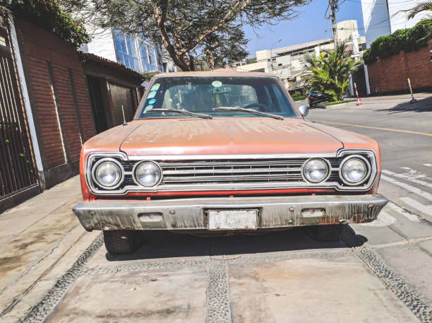 istock Old rusty and dusty car parked in a quiet street. 1451864979