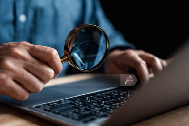 istock Businessman use magnifying glass Search On Virtual Screen Data Search Technology Search Engine Optimization. Man use computer to Searching for information. Using Search Console for data. 1451865852