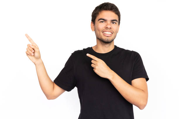 istock Happy young man pointing finger at ads 1451869072
