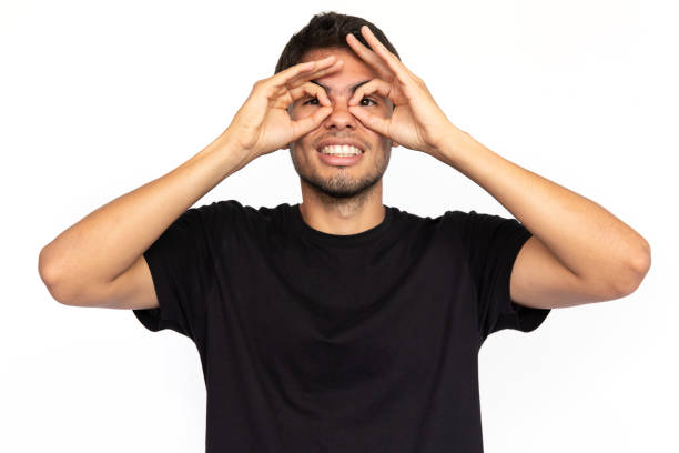 istock Excited young man doing glasses gesture 1451871336