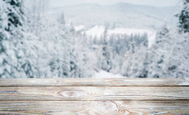 istock Light wooden background with snowy mountains. 1451873349