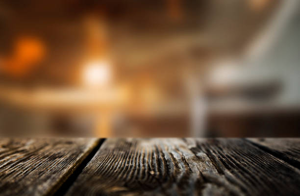 istock Brown dark wood texture background with blurry lights 1451873452