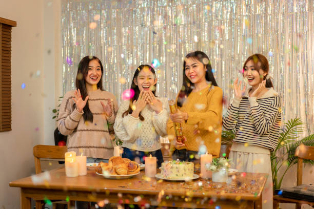 istock Young beautiful woman playing and pull poppers confetti party with enjoying while celebrating in new year party at home 1451873847
