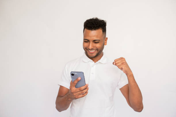 istock Satisfied young man looking at smartphone screen 1451875659
