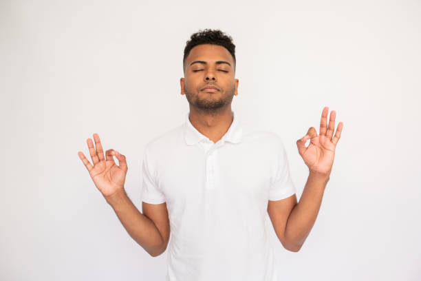 istock Relaxed young man meditating with closed eyes 1451875790