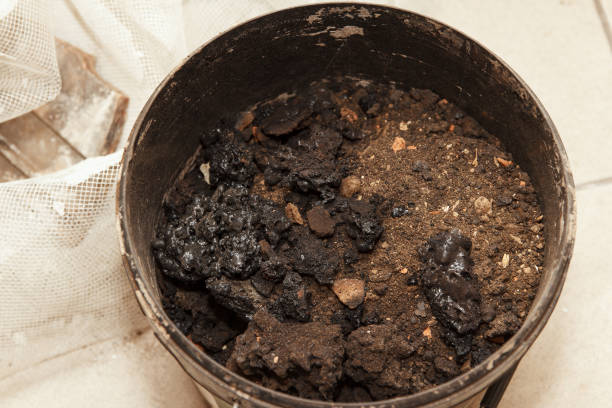 Ash cleaning, a combustion product that remains in stoves from burning firewood and coal. Garbage, which was collected in a bucket, after cleaning the stove stock photo