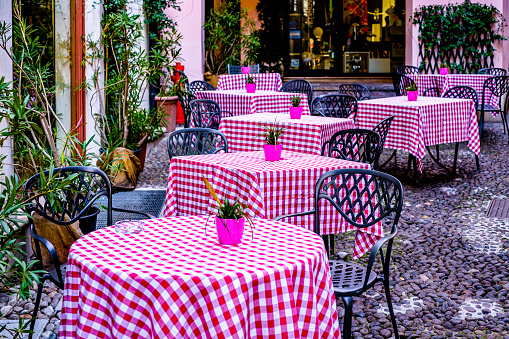 chairs at a sidewalk cafe - italy