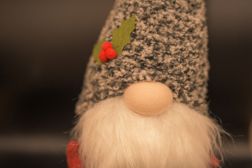 A Christmas Gonk cute fluffy white beard and speckled grey hat with felt holly leaves and berries, warmth of Christmas