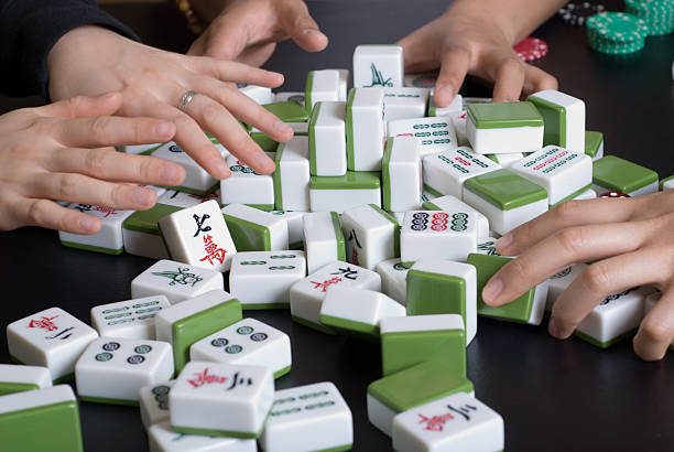 istock Mah Jong Players Shuffle Tiles at a Table 145188226