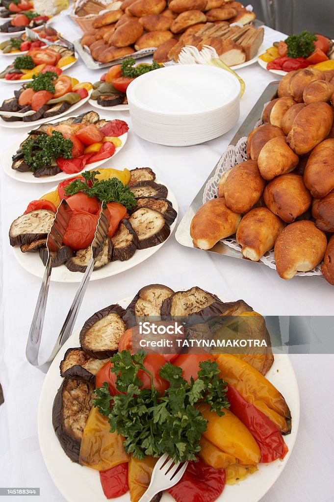 Buffet table Snack on a table from an eggplant a tomato, rolls Abundance Stock Photo