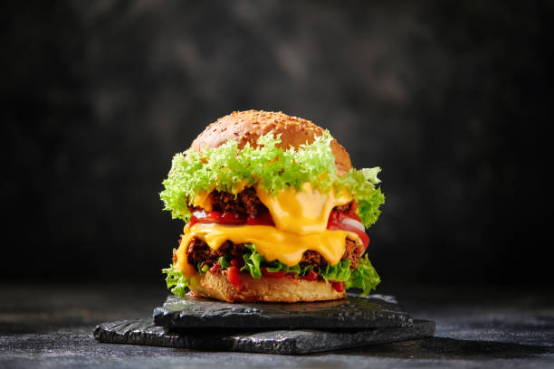 Fresh tasty burger on dark background stock photo