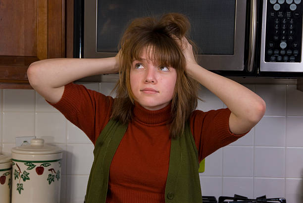 Girl in kitchen stock photo