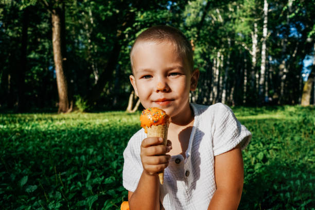 istock Happy boy shows ice cream on camera. 1451887234