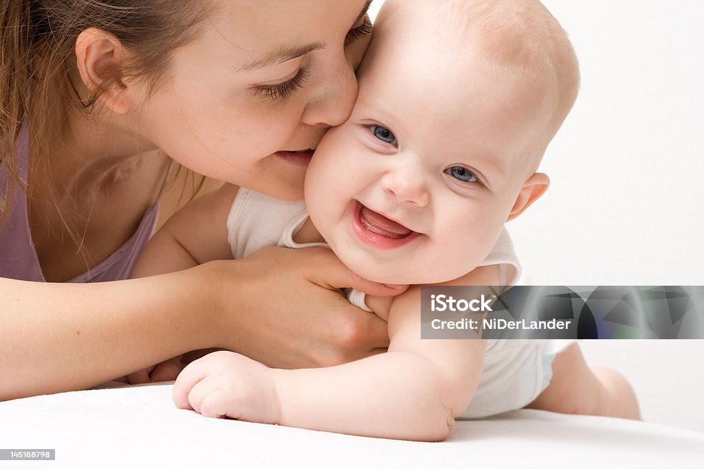 Mother's love Mother's love. Cute baby 6 month with mother. Adult Stock Photo