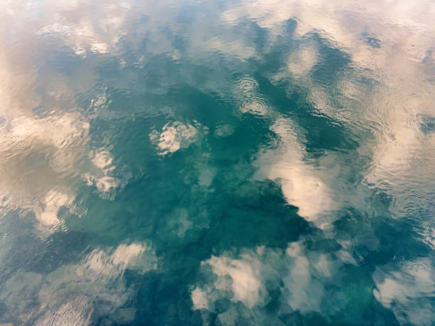istock Reflection of sky clouds on the water of a river 1451897992