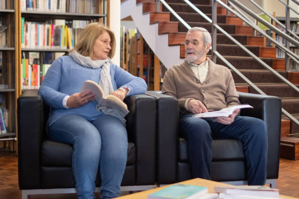 Serious aged people reading thematic books