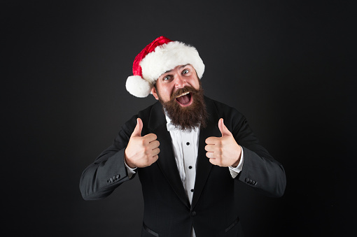 Cheerful mood. Happiness and joy. Corporate christmas party. Man bearded hipster wear santa hat. Christmas spirit concept. Manager celebrate new year. Christmas party. Corporate holiday ideas.