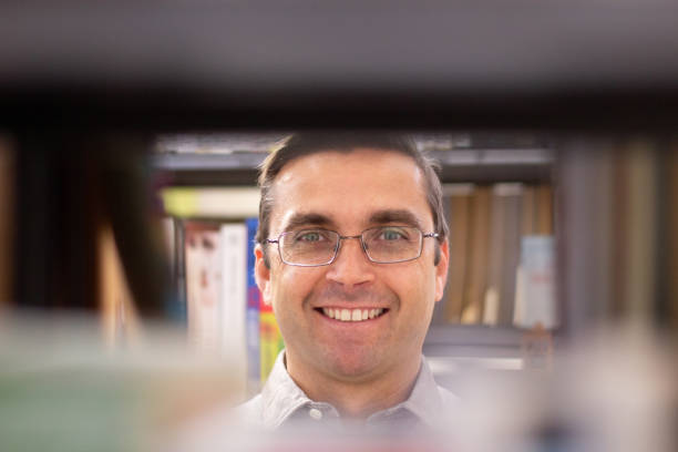 istock Portrait of happy middle-aged man in library 1451904801