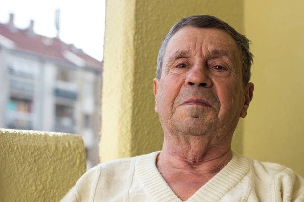 Senior man with a serious look on his face. Thoughtful man sitting at home