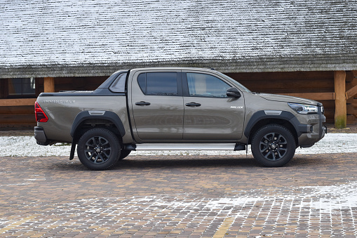 Zdiar, Slovakia - 9th January, 2022: Toyota Hilux Invincible stopped on a street in winter scenery. The Hilux is one of the most popular pick-up vehicles in the world.