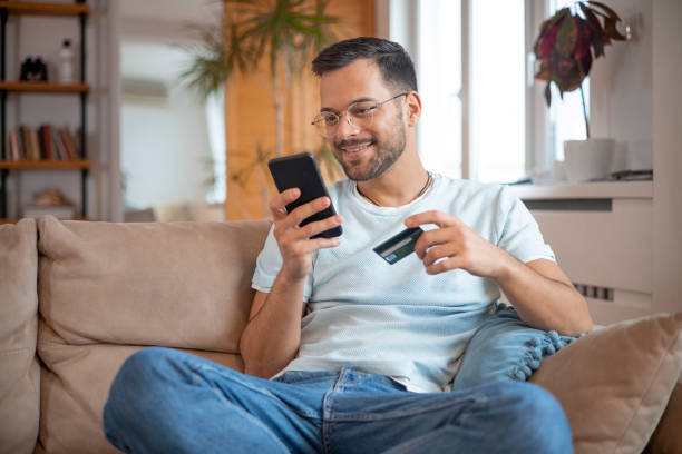 istock Man using his credit card to shop online 1451909409