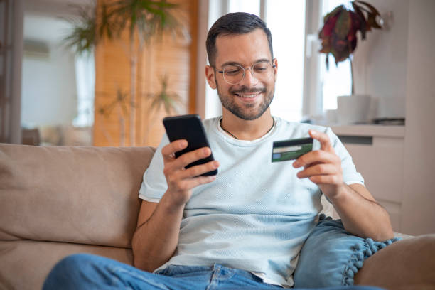 istock Man using his credit card to shop online 1451909411